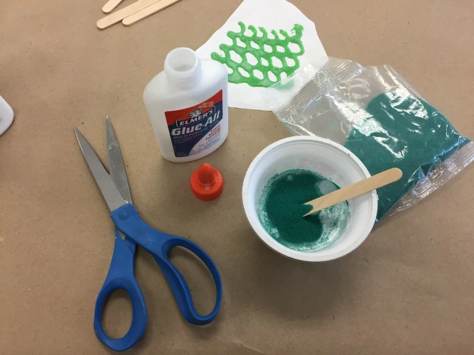 Mix colored sand into glue to create glue paint.